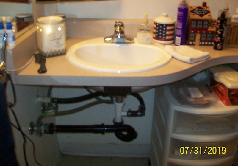 Showing ADA unit vanity top before showing no room for wheelchair.